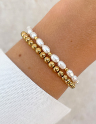 Bracelet on an elastic band with khaki cubic zirconia and natural pearl