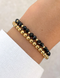 Bracelet on an elastic band with khaki cubic zirconia and natural pearl