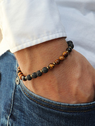 Bracelet on an elastic band with khaki cubic zirconia and natural pearl