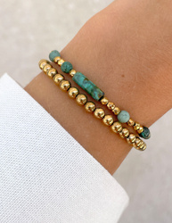 Bracelet on an elastic band with khaki cubic zirconia and natural pearl