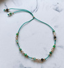 Bracelet natural stones zoisite with ruby ​​zircon, champagne, silk thread