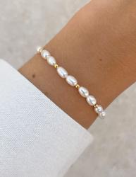 Bracelet on an elastic band with khaki cubic zirconia and natural pearl