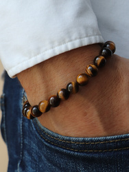 Bracelet on an elastic band with khaki cubic zirconia and natural pearl