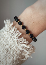 Bracelet on an elastic band with khaki cubic zirconia and natural pearl