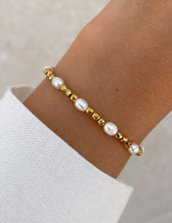 Bracelet on an elastic band with khaki cubic zirconia and natural pearl