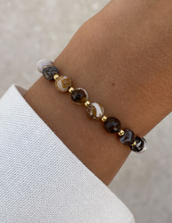 Bracelet on an elastic band with khaki cubic zirconia and natural pearl