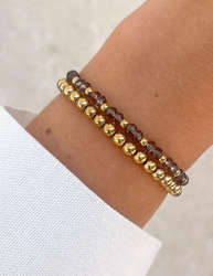 Bracelet on an elastic band with khaki cubic zirconia and natural pearl