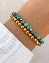 Bracelet on an elastic band with khaki cubic zirconia and natural pearl