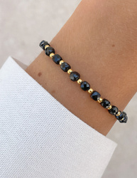 Bracelet on an elastic band with khaki cubic zirconia and natural pearl