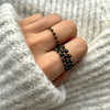Elastic black spinel ring with gold-plated balls