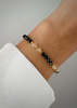 Bracelet on an elastic band with khaki cubic zirconia and natural pearl