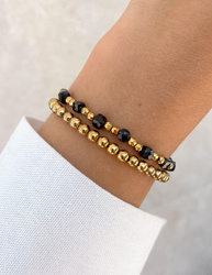 Bracelet on an elastic band with khaki cubic zirconia and natural pearl