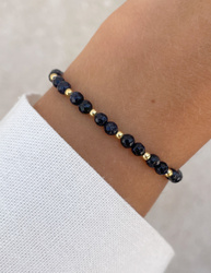 Bracelet on an elastic band with khaki cubic zirconia and natural pearl