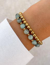 Bracelet on an elastic band with khaki cubic zirconia and natural pearl