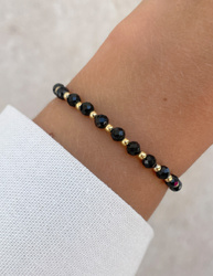 Bracelet on an elastic band with khaki cubic zirconia and natural pearl