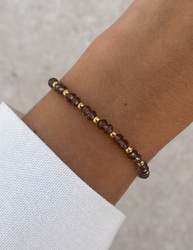 Bracelet on an elastic band with khaki cubic zirconia and natural pearl