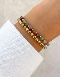 Bracelet on an elastic band with khaki cubic zirconia and natural pearl